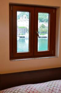 a bedroom window with a view of a body of water at Apartments Qualitas in Kotor