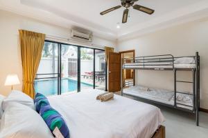 a bedroom with two bunk beds and a pool at AnB poolvilla 2BR with private beach in pratamnak in Pattaya South