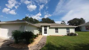 a white house with a grass yard at Villa Willow Wood - Golfcourse in Inverness