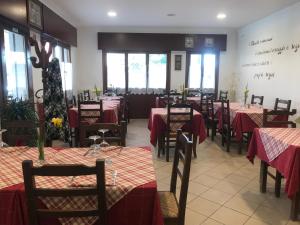 a restaurant with tables and chairs with red table cloth at Oasis Lagoon Estate in Venice-Lido