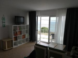 a living room with a view of the ocean at Cozy studio #1, with balcony in 2 Mai