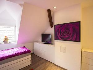 a bedroom with a bed and a tv on a wall at Ferienwohnung Innenstadt in Oberkirch