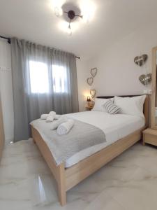 a bedroom with a large bed with two towels on it at ROOF TOP in Limenas