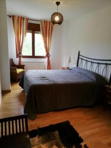 - une chambre avec un grand lit et une fenêtre dans l'établissement Apartamento Usarena en Ezcaray, à Zorraquín