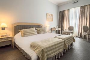 A bed or beds in a room at Airotel Stratos Vassilikos Hotel