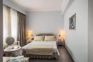 A bed or beds in a room at Airotel Stratos Vassilikos Hotel