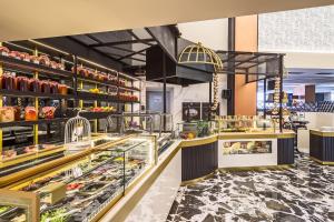 a bakery with a variety of pastries on display at Airotel Stratos Vassilikos Hotel in Athens