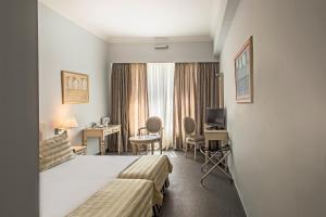 A bed or beds in a room at Airotel Stratos Vassilikos Hotel