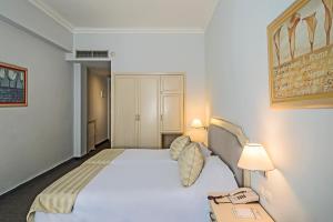 A bed or beds in a room at Airotel Stratos Vassilikos Hotel