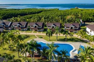 an aerial view of a resort with a pool and palm trees at North Zen Villas in Panglao