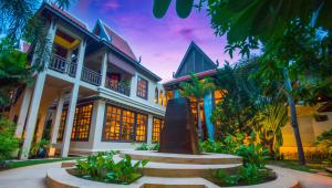a house with a fountain in front of it at Borei Angkor Resort & Spa in Siem Reap