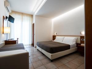 Postel nebo postele na pokoji v ubytování Hotel Florence
