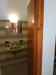 a bathroom with a sink and a mirror at Dimitra appartements in Argostoli