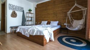a bedroom with a swinging bed and a hammock at The Monkee Studios in Sveti Vlas