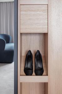a pair of black shoes sitting in a cabinet at Copenhagen Admiral Hotel in Copenhagen