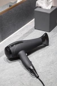 a black iron on the floor next to a box at Copenhagen Admiral Hotel in Copenhagen