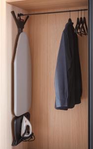 a room with a wall with a coat and a helmet at Copenhagen Admiral Hotel in Copenhagen