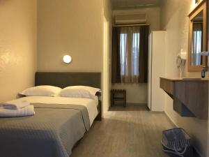a hotel room with two beds and a window at Sailor's Nautical Concept in Spetses