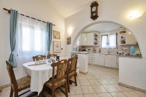 cocina con mesa y sillas y cocina con reloj en Villa Amelie, en Kaštelir