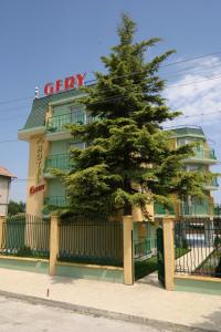 a pine tree in front of a building at Family Hotel Gery in Kranevo