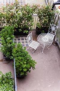 a patio with a table and chairs and plants at Alessia's Place in Como