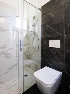 a bathroom with a toilet and a shower at Hotel Florence in Marotta