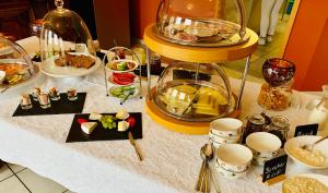a table topped with food and plates of food at Das Landhaus Apartments in Prüm