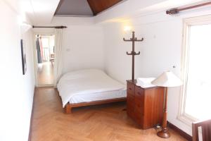a small room with a bed and a cross on the wall at Davidduc 224 Âu Cơ in Hanoi