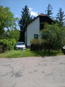 a car parked in front of a house at ZENITH APARTMAN in Gárdony