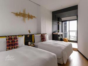 Un pat sau paturi într-o cameră la Hido Hostel