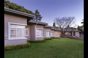 a row of houses with a green yard at 6 On Acacia in Johannesburg