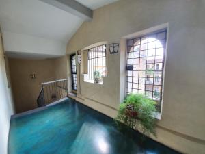 an indoor swimming pool in a room with two windows at Palatina apartment in Turin