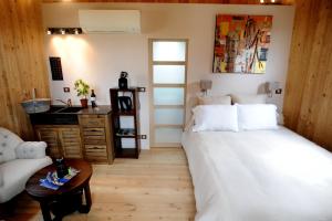 a bedroom with two beds and a table and a desk at Coup 2 Foudres in Saint-Jean-de-Blaignac
