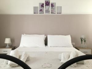 מיטה או מיטות בחדר ב-Cimalù by Lampara