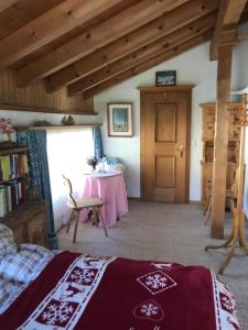 a bedroom with a bed and a table in a room at Studio in Klosters in Klosters