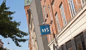 a blue sign on the side of a building at Rye115 Hotel in Copenhagen