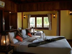 a bedroom with a large bed and a window at Koh Mook Sivalai Beach Resort in Ko Mook