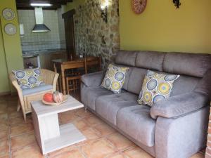 sala de estar con sofá y mesa en Casa Rural El Jondrigu, en Cangas de Onís