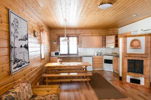 a kitchen with a table and a couch in a room at Ruoke Holiday Village in Kesälahti +74 photos