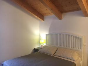 a bedroom with a bed and a wooden ceiling at Al Libro Letto in Viterbo