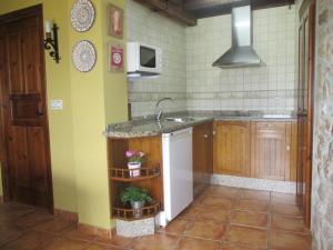 a kitchen with a sink and a counter top at Casa Rural El Jondrigu in Cangas de Onís +24 photos