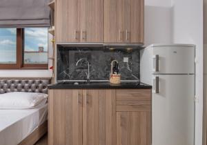 a kitchen with a sink and a refrigerator at Jolandas Suites in Toroni