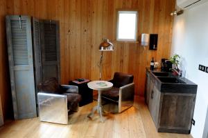 a kitchen with a table and two chairs and a sink at Coup 2 Foudres in Saint-Jean-de-Blaignac