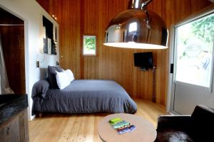 a bedroom with a bed and a table in a room at Coup 2 Foudres in Saint-Jean-de-Blaignac