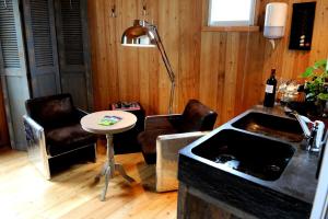 a kitchen with a table and two chairs and a sink at Coup 2 Foudres in Saint-Jean-de-Blaignac