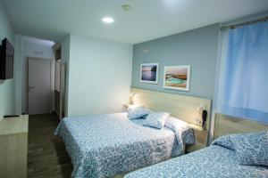 Posteľ alebo postele v izbe v ubytovaní Hotel Bari