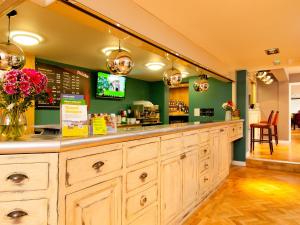 a restaurant with a counter with flowers on it at YHA Stratford-Upon-Avon in Stratford-upon-Avon