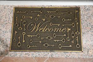 a sign with the word welcome on a floor at Apartments Bartol in Rovinj