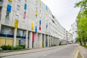 a building with colored windows on the side of a street at Harbour Hub Hostel in Tallinn