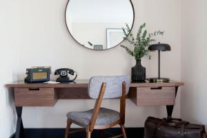 a desk with a mirror and a chair at The Alex in Dublin